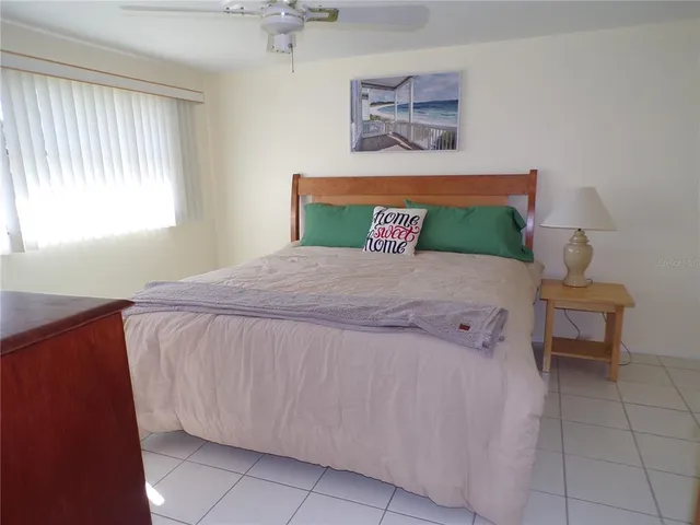 a bedroom with a bed and a table