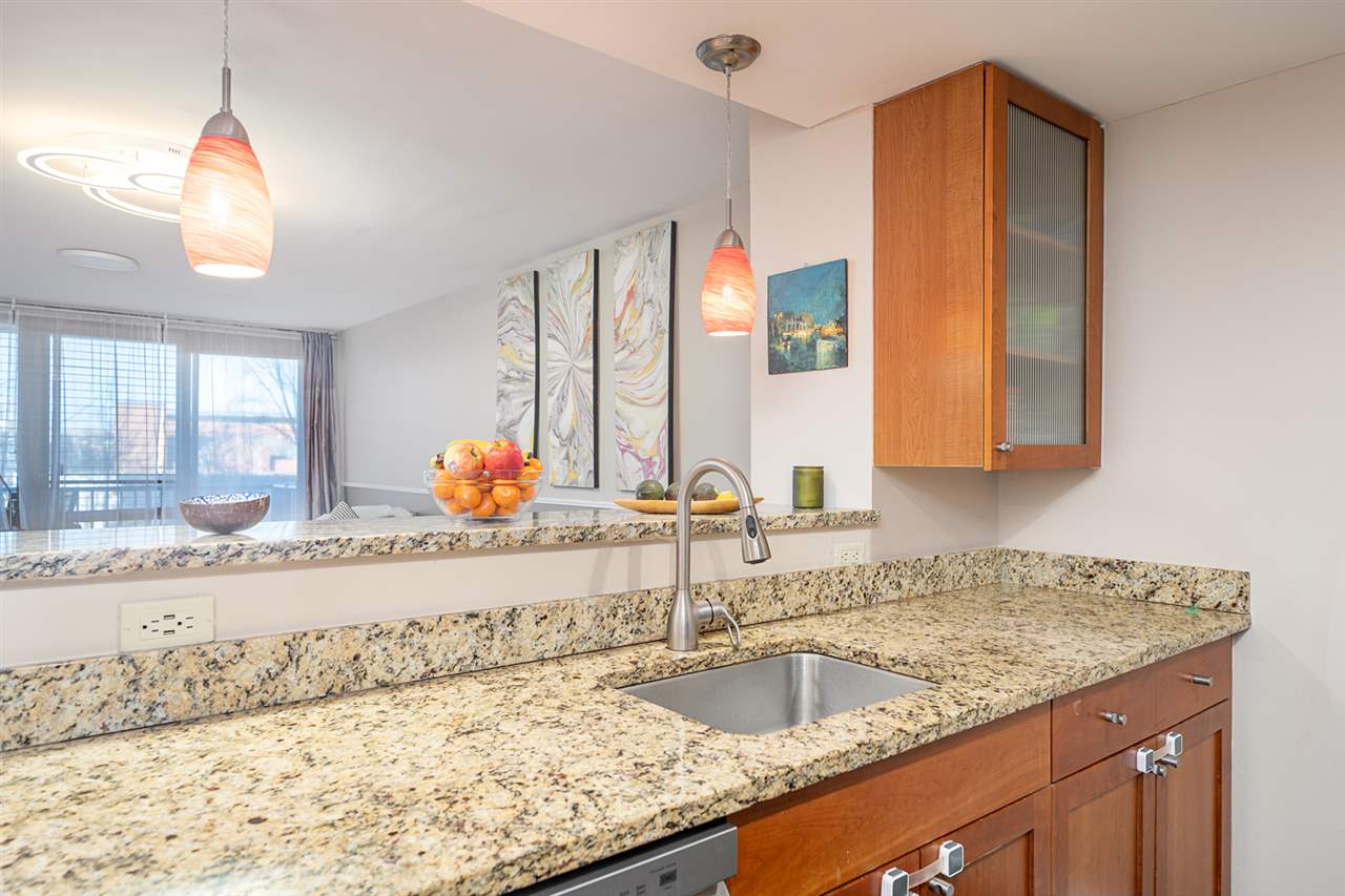 700 Grove Street, Unit 4V Jersey City, NJ 07310 - Photo 11 of 25 a kitchen with a granite countertop sink and a granite counter tops