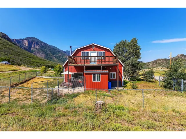 a view of a yard with a house in the background