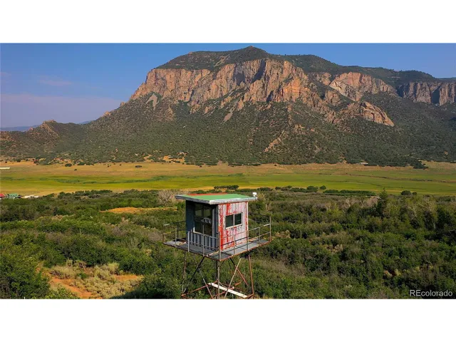 a bedroom with a bed and a flat tv screen on the dresser
