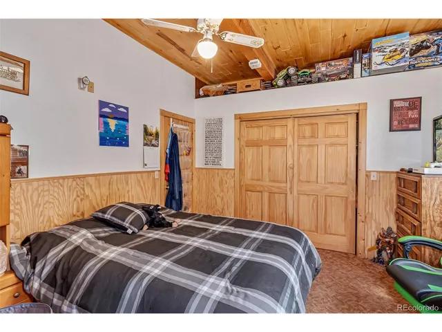 a living room with furniture a large window and chandelier