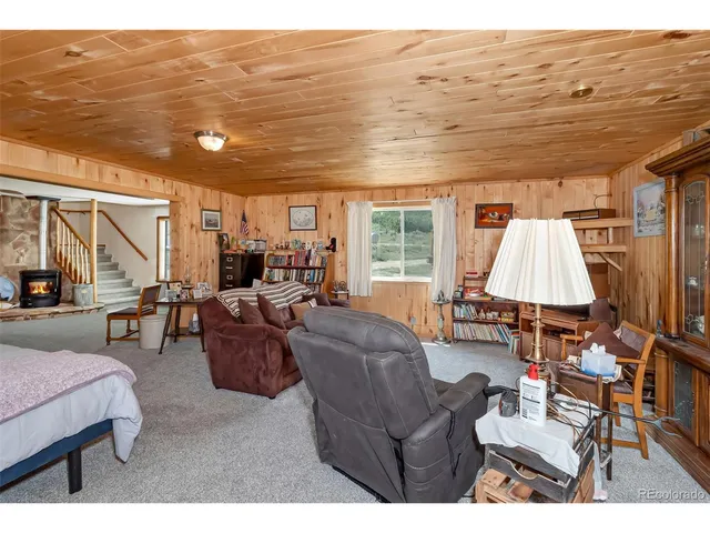 a bedroom with a bed table and window