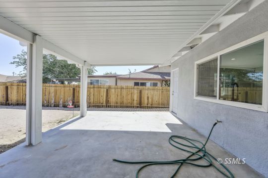 240 West Benson Avenue Ridgecrest, CA 93555 - Photo 26 of 29 a view of a porch with a table and chairs
