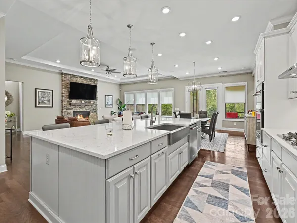 a large kitchen with kitchen island a sink appliances and a large window