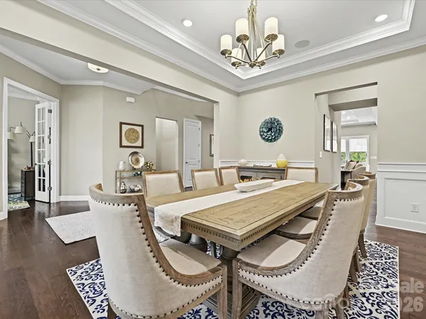 a living room with a table chairs and a dining table