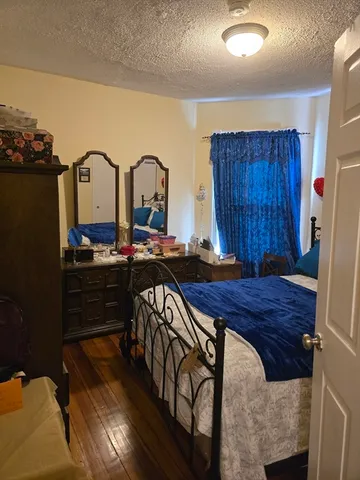 a bed sitting in a room next to a window