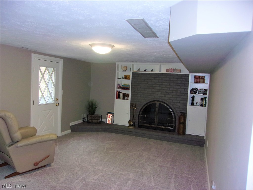 546 Spring Pond Road Northfield, OH 44067 - Photo 9 of 20 Step down to family room with wood burning fireplace and built-ins