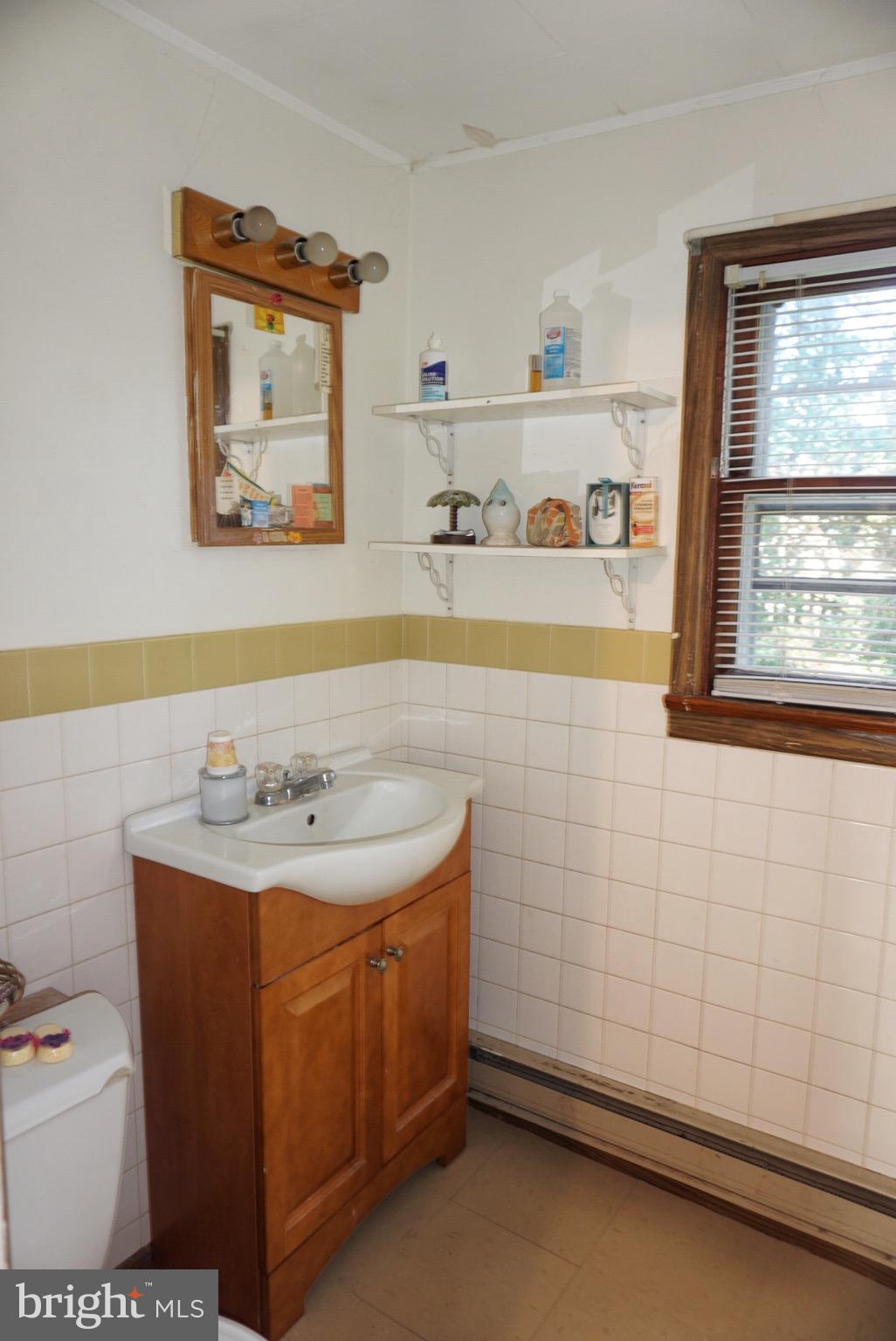 1812 Conowingo Road Forest Hill, MD 21050 - Photo 8 of 21 a bathroom with a sink a toilet and a window