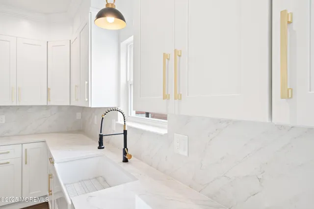 a large kitchen with stainless steel appliances kitchen island granite countertop a sink a stove and a wooden floors