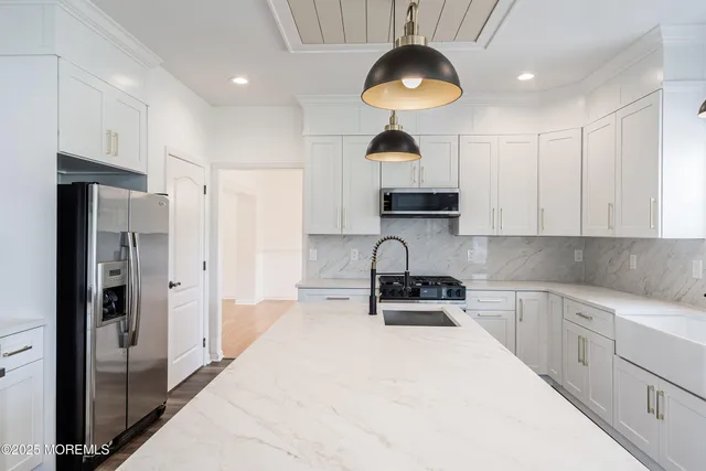 a kitchen with stainless steel appliances a refrigerator stove and microwave