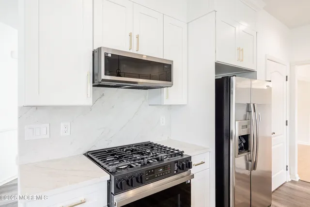 a kitchen with stainless steel appliances a sink a stove and a window