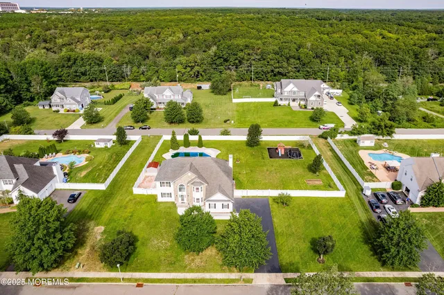 an aerial view of a house with a swimming pool