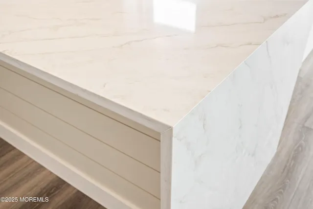 a view of kitchen with wooden floor and electronic appliances
