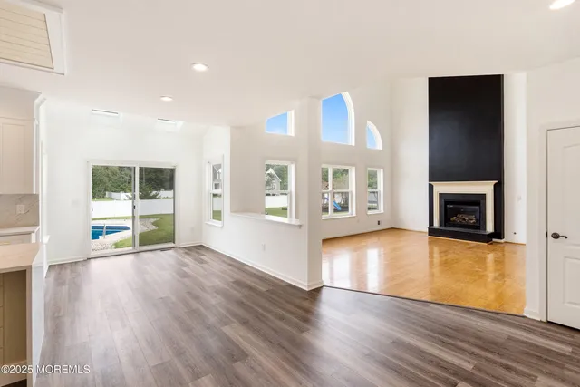 a view of an empty room with a fireplace and a window