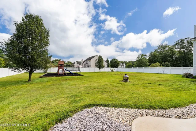 a view of a house with a yard and sitting area