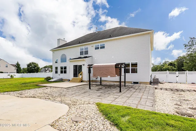 a swimming pool with outdoor seating and yard
