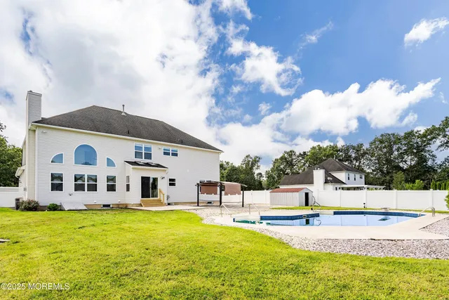a view of a swimming pool with a yard