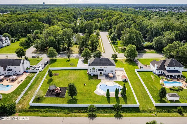 an aerial view of a house with a swimming pool yard and outdoor seating