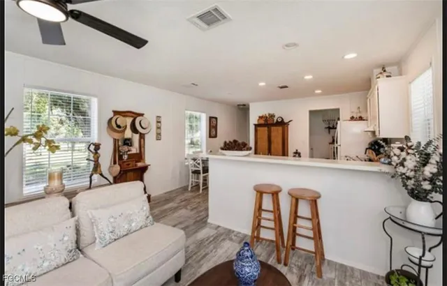 a living room with furniture and flowers