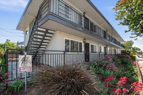 a view of a house with wooden fence