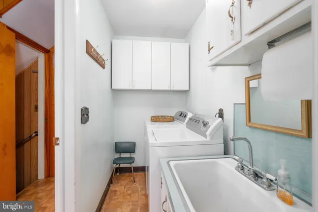a bathroom with a sink and a washer dryer