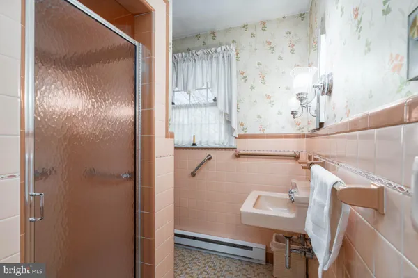 a bathroom with a shower and a sink