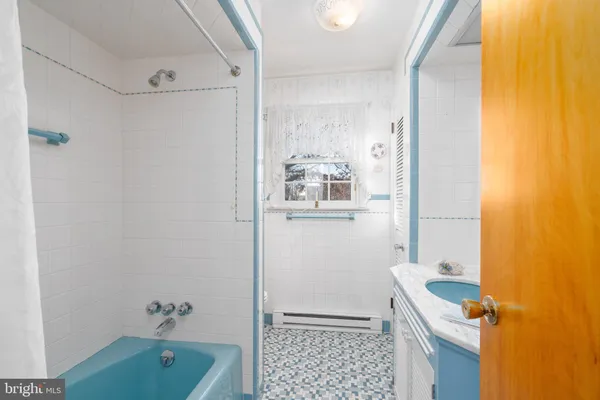 a bathroom with a sink a toilet a shower and a mirror
