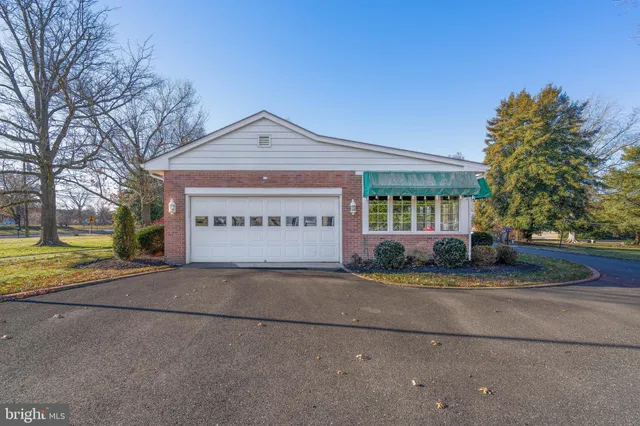 a view of a house with a yard and potted plants
