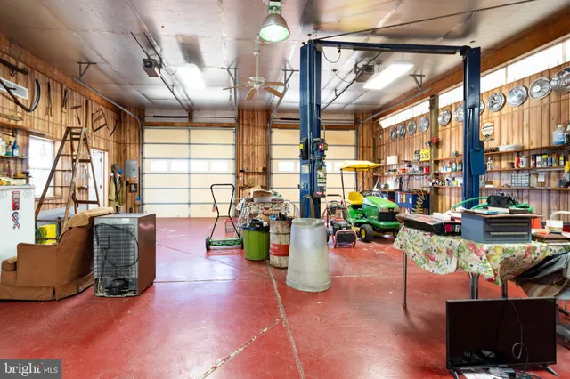 a living room with fireplace furniture and floor to ceiling windows