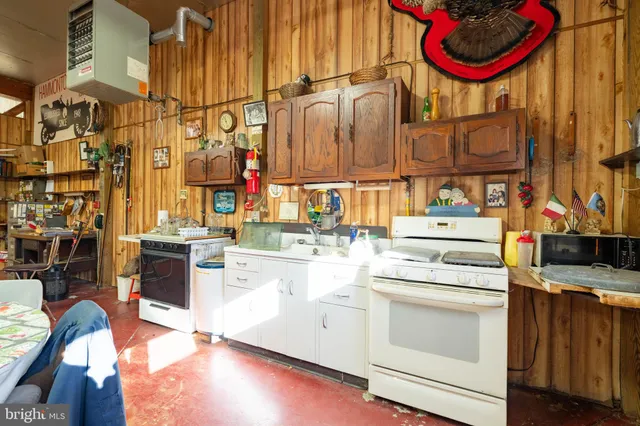 a kitchen with stainless steel appliances granite countertop a stove and cabinets