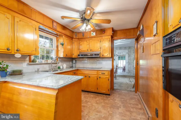 a kitchen with stainless steel appliances granite countertop a sink and a refrigerator