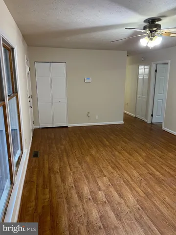 wooden floor in an empty room with a mirror