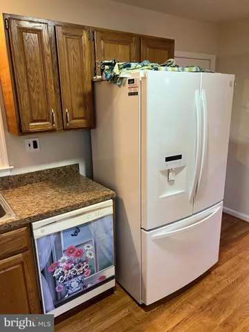 a white refrigerator freezer sitting inside of a kitchen