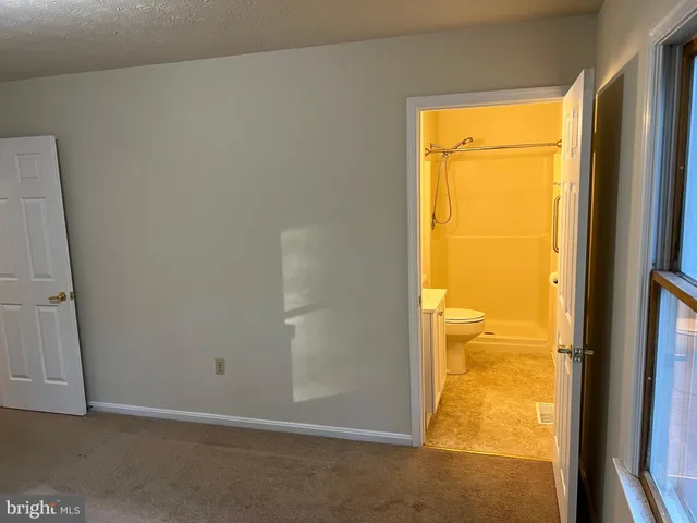 a bathroom with a toilet sink and shower