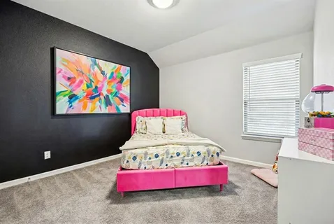 a bedroom with a bed and window