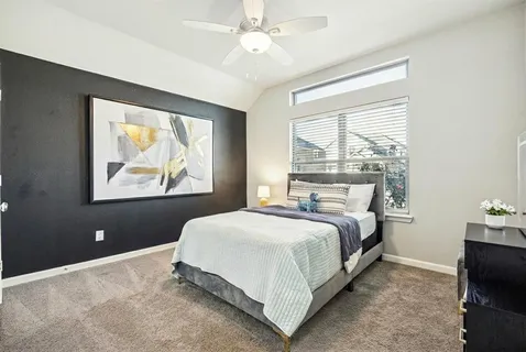 a bedroom with a bed and a painting on the wall