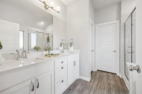 a bathroom with a double vanity sink and mirror