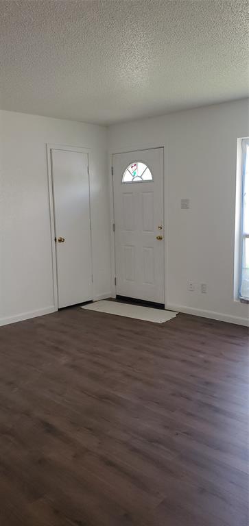 709 Lee Street, Unit 12 Mesquite, TX 75149 - Photo 2 of 5 an empty room with wooden floor and windows