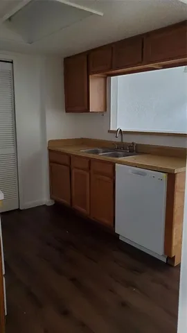 a kitchen with granite countertop a sink and a stove top oven