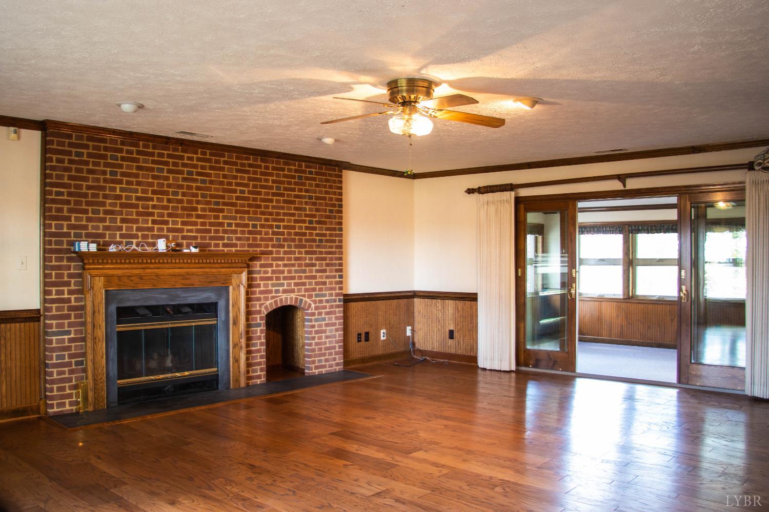 7941 Sugar Hill Road Brookneal, VA 24528 - Photo 14 of 76 a view of a livingroom with a fireplace and wooden floor