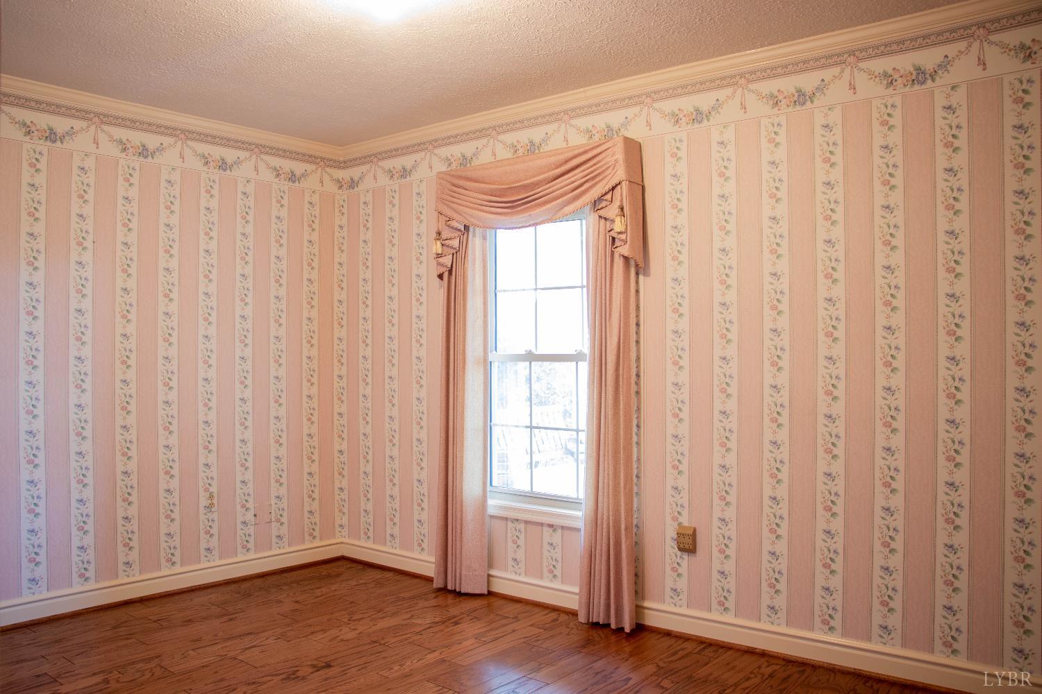 7941 Sugar Hill Road Brookneal, VA 24528 - Photo 24 of 76 a view of an empty room with wooden floor and a window