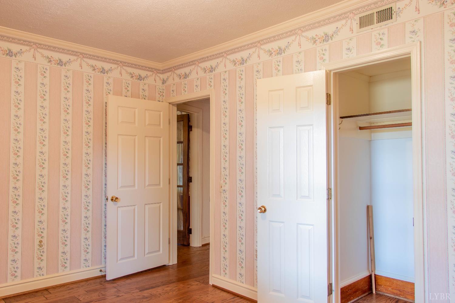 7941 Sugar Hill Road Brookneal, VA 24528 - Photo 25 of 76 a view of a hallway with wooden floor