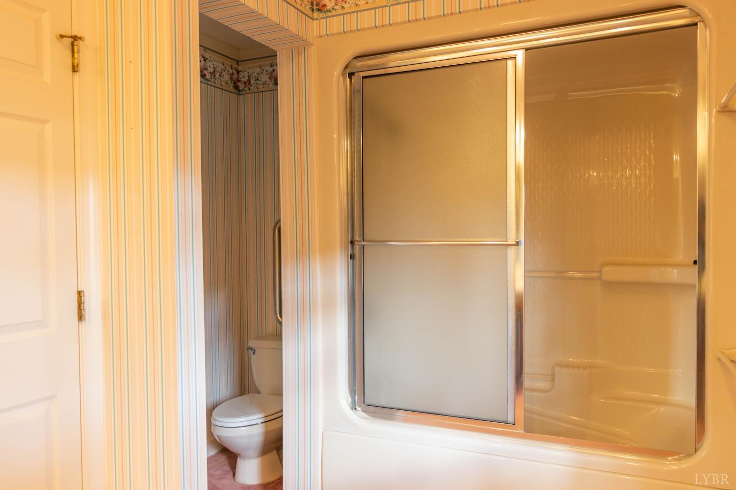 7941 Sugar Hill Road Brookneal, VA 24528 - Photo 33 of 76 a bathroom with a glass shower door