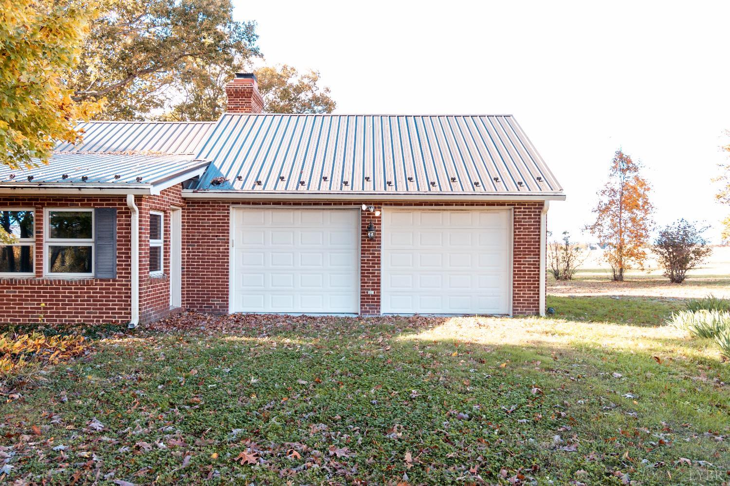 7941 Sugar Hill Road Brookneal, VA 24528 - Photo 35 of 76 a view of a house with a yard and garage