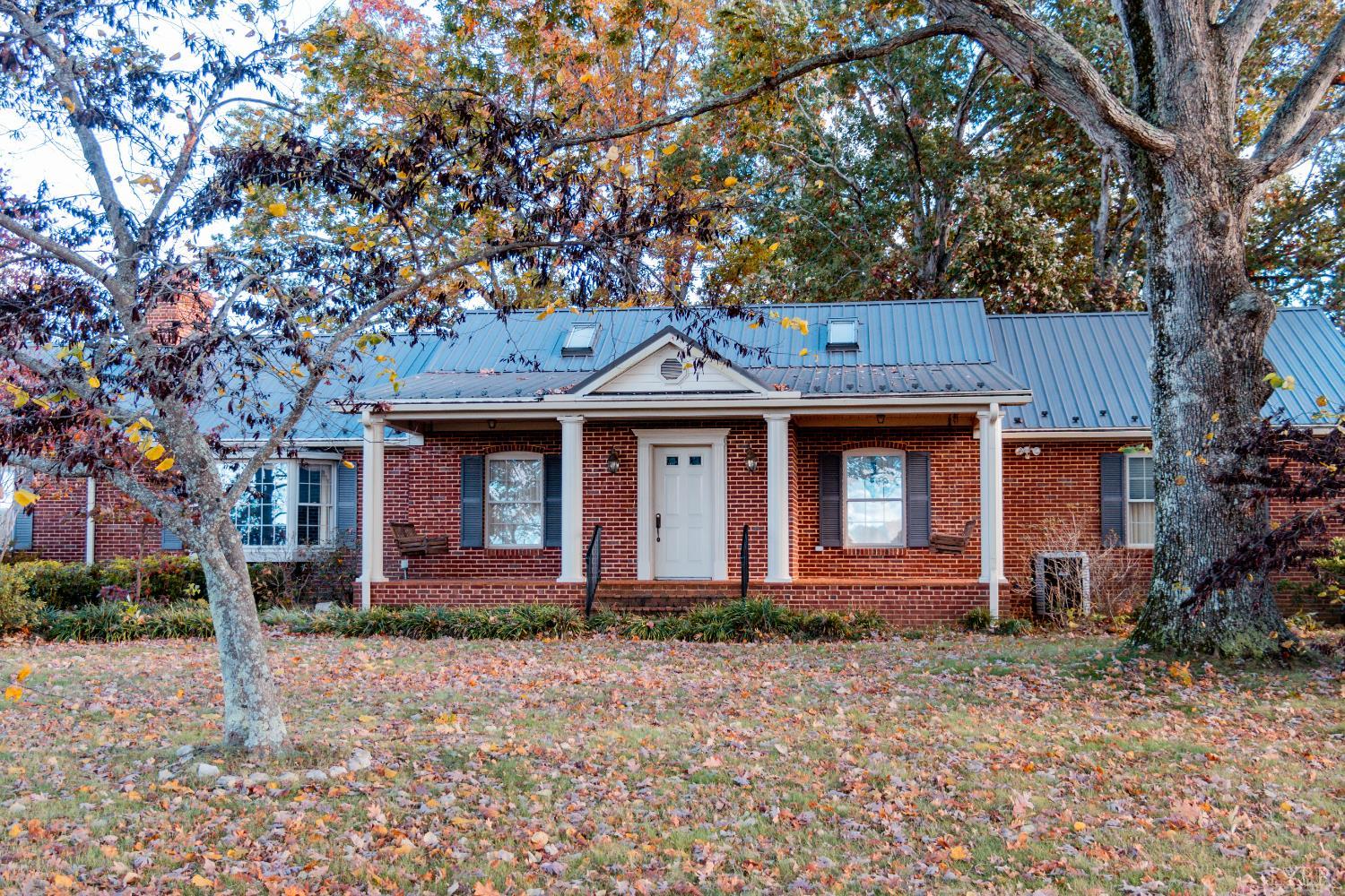 7941 Sugar Hill Road Brookneal, VA 24528 - Photo 44 of 76 a front view of a house with garden