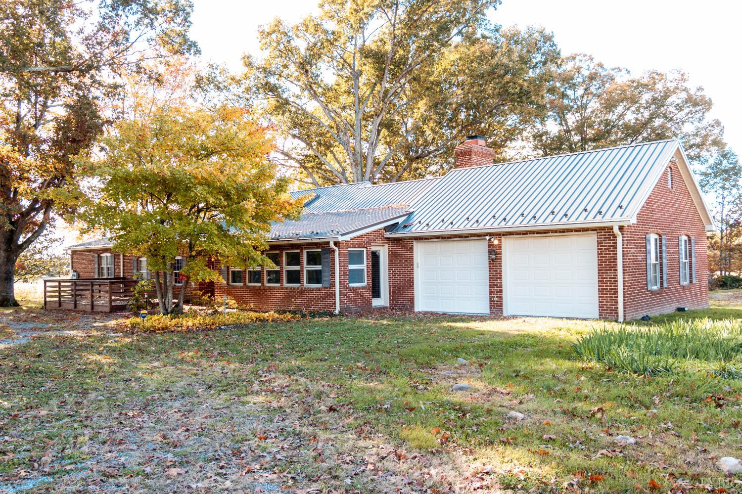 7941 Sugar Hill Road Brookneal, VA 24528 - Photo 63 of 76 a front view of a house with a yard and trees