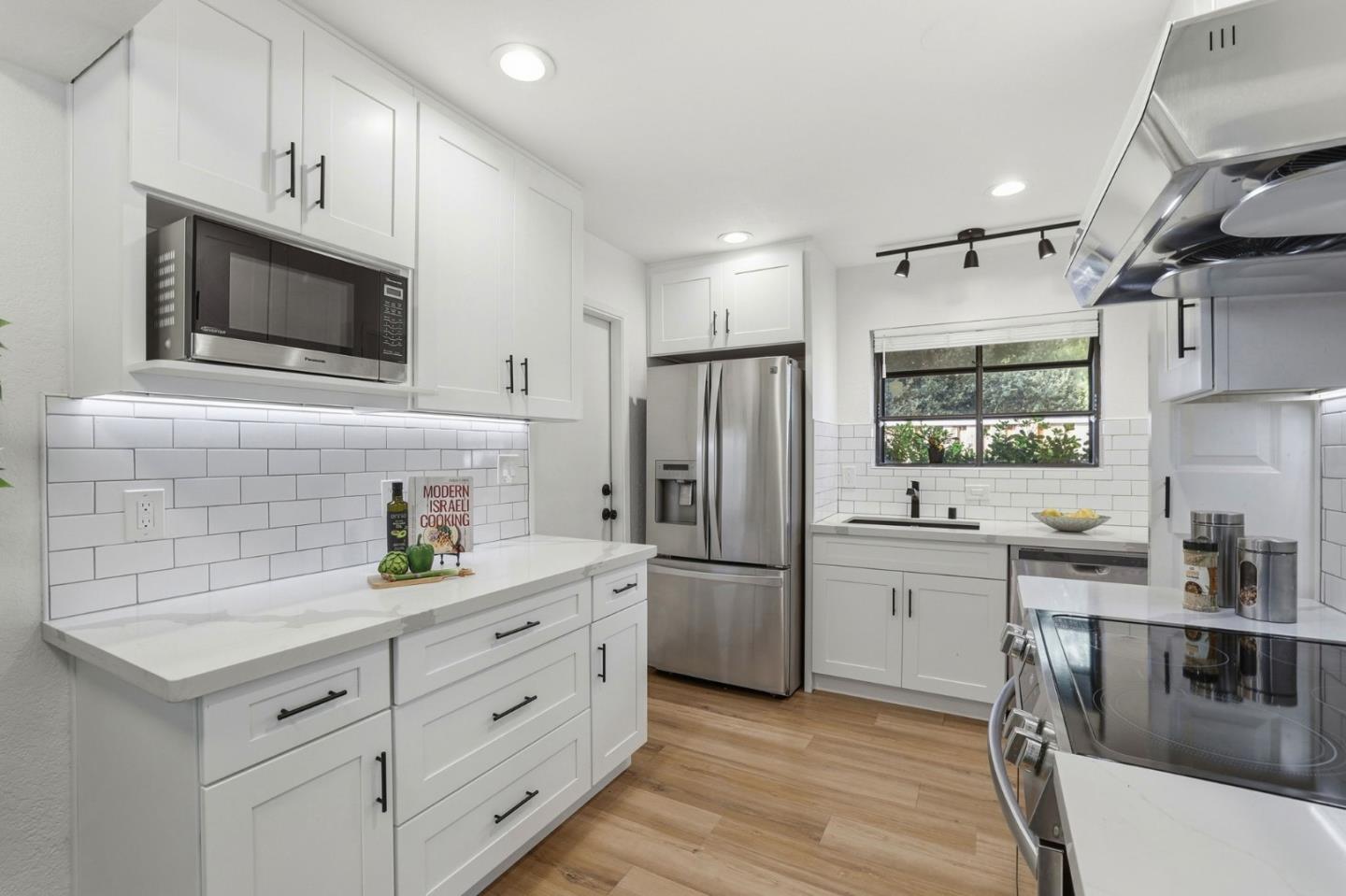 709 Winstead Court Sunnyvale, CA 94087 - Photo 5 of 21 a kitchen with white cabinets stainless steel appliances and sink