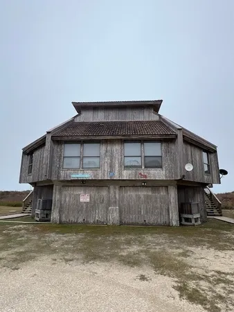 a view of a house with a wooden fence