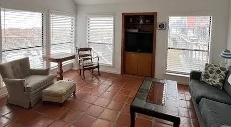 a living room with furniture and a floor to ceiling window