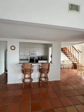 a dining hall with a dining table and a chairs